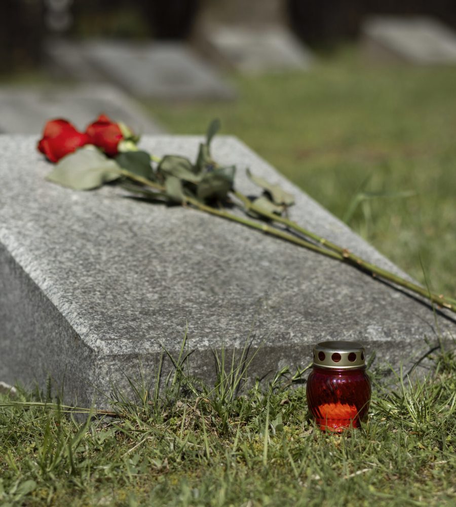 view-gravestone-with-flowers-candle